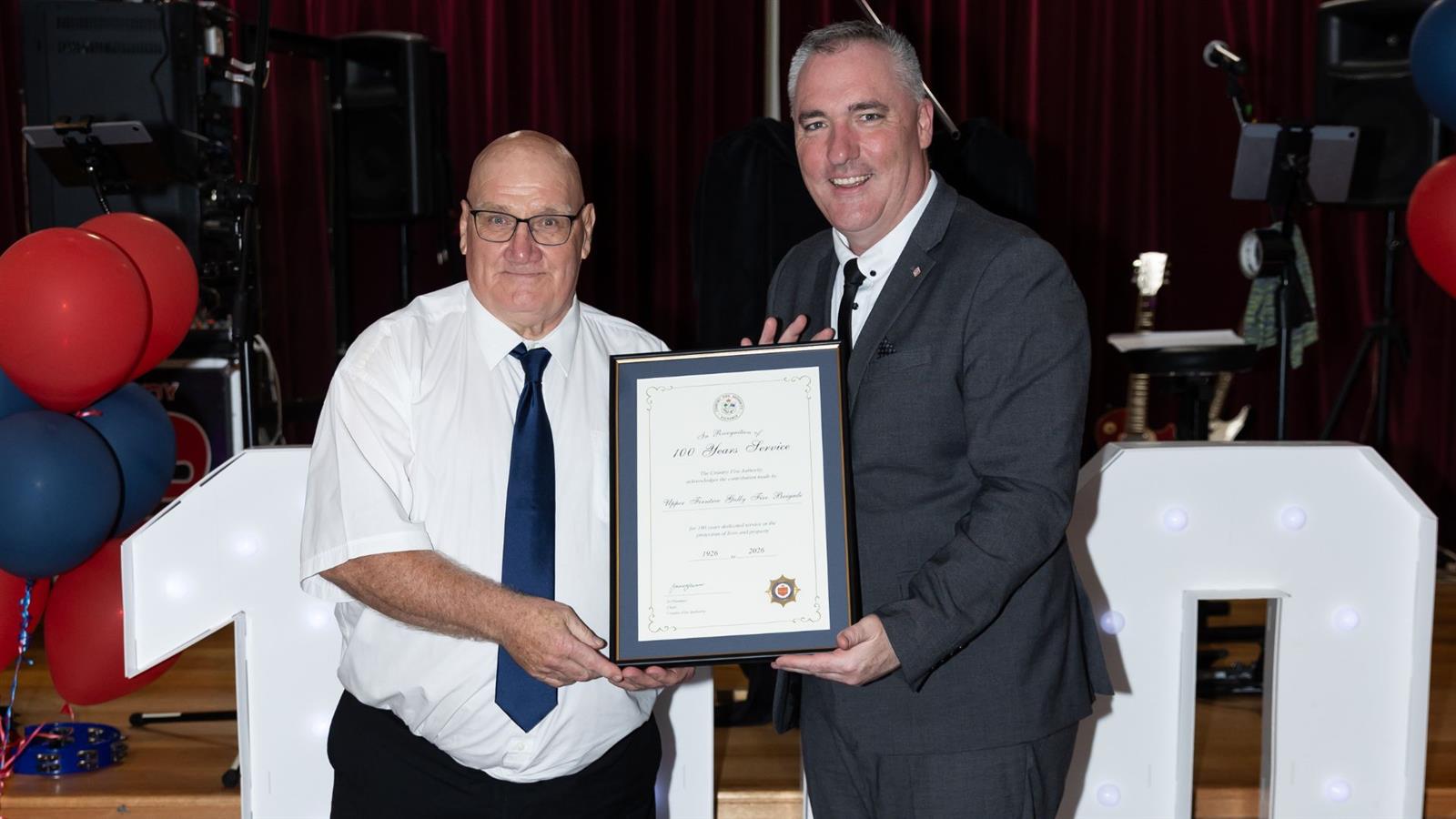 CO Jason Heffernan presenting 100 years of service to Captain Peter Smith